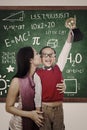 Cheerful boy wins Math trophy kiss by mother Royalty Free Stock Photo