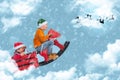 Cheerful boys sitting on a sleigh and rocking horse on a blue magical background with Christmas clouds