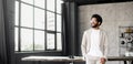 A cheerful Brazilian businessman in a smart casual beige suit in loft office Royalty Free Stock Photo