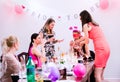 Cheerful bride and bridesmaids celebrating hen party with drinks