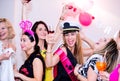 Cheerful bride and bridesmaids celebrating hen party with drinks