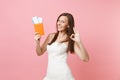 Cheerful bride woman in white wedding dress showing OK sign, holding passport and boarding pass ticket, going abroad for Royalty Free Stock Photo