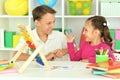 Cheerful brother and sister doing homework together