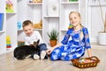 Cheerful brother and sister playing with a rabbit