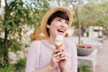 Cheerful brunette girl holding tasty ice cream looking away with happy smile. Close-up portrait of amazing young woman Royalty Free Stock Photo