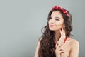 Cheerful brunette model woman smiling and looking up on gray banner background Royalty Free Stock Photo