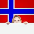 Cheerful brunette woman showing white banner on the Norway flag