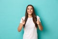 Cheerful brunette woman in white t-shirt, congratulating you, pointing fingers at camera, smiling pleased, praising good