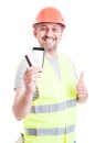 Cheerful builder paying with credit card Royalty Free Stock Photo