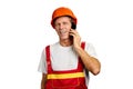 Cheerful builder talking on cell phone.