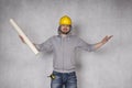 Cheerful builder throws up his hands in a gesture of victory