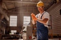 Cheerful builder using woodworking machine in workshop Royalty Free Stock Photo