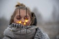 Burning sparklers on the background of a blurred portrait of a girl in nature Royalty Free Stock Photo
