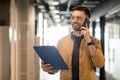 Cheerful Business Man Talking On Smartphone Walking In Modern Office