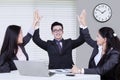 Cheerful business partners raising arms up Royalty Free Stock Photo