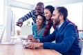 Cheerful business people looking at computer screen