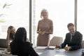 Cheerful business team with mature leader woman through glass shot