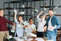 Portrait of cheerful business team of multi-ethnic employees celebrating victory and big profit. Royalty Free Stock Photo