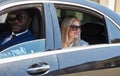 Cheerful business woman in car with personal driver