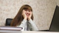 Cheerful business woman sits in black leather chair talking and laughing and singing song in workplace at table. happy Royalty Free Stock Photo