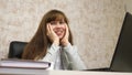 Cheerful business woman sits in black leather chair talking and laughing and singing song in workplace at table. happy Royalty Free Stock Photo