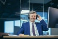 Businessman on a break listening to music and dancing with big headphones, senior and experienced gray-haired man working Royalty Free Stock Photo