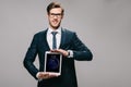 Cheerful businessman holding digital tablet with lock screen isolated