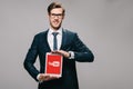 Cheerful businessman holding digital tablet with youtube app on screen isolated