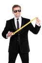 Cheerful businessman measuring the length of business success wi