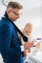 cheerful businessman smartphone and infant daughter