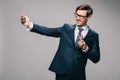 Cheerful businessman taking selfie and showing piece sign Royalty Free Stock Photo