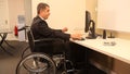 Cheerful businessman with wheelchair