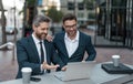 cheerful businessmen trading online with laptop. photo of businessmen trading online. Royalty Free Stock Photo