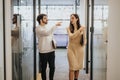 Cheerful businesspeople discussing and strategizing together in a corporate office.