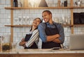 Cheerful businesspeople standing in their cafe kitchen. Business partners standing back to back in their coffeeshop. Two Royalty Free Stock Photo