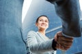 Cheerful businesswoman and client handshaking