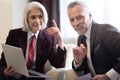 Cheerful businesswoman and her colleague working with the laptop Royalty Free Stock Photo