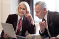 Cheerful businesswoman and her colleague working with the laptop Royalty Free Stock Photo