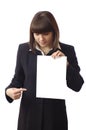 Cheerful businesswoman points finger on document