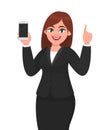 Cheerful businesswoman showing blank screen mobile, cell or smart phone and gesturing hand pointing finger up. Mobile phone.