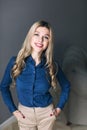 Cheerful businesswoman standing over gray background Royalty Free Stock Photo