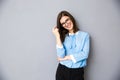 Cheerful businesswoman standing over gray background Royalty Free Stock Photo