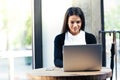 Cheerful businesswoman using laptop in cafe Royalty Free Stock Photo