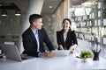 Businesswoman working on new project with her colleague in office. Royalty Free Stock Photo