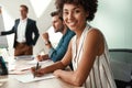 Cheerful businesswoman. Young afro american woman is looking at camera and smiling while her boss standing near Royalty Free Stock Photo