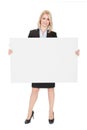 Cheerful businesswomen presenting empty board Royalty Free Stock Photo