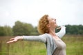 Cheerful carefree woman with arms outstretched Royalty Free Stock Photo