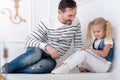 Cheerful caring father helping his daughter with the home task Royalty Free Stock Photo