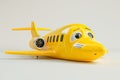 A cheerful cartoon airplane featuring a wearied expression against a plain white background Royalty Free Stock Photo