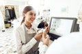 Cheerful cashier using digital device for payment Royalty Free Stock Photo